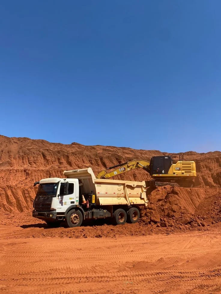 SGT excavator loading a dump truck at a laterite mining site